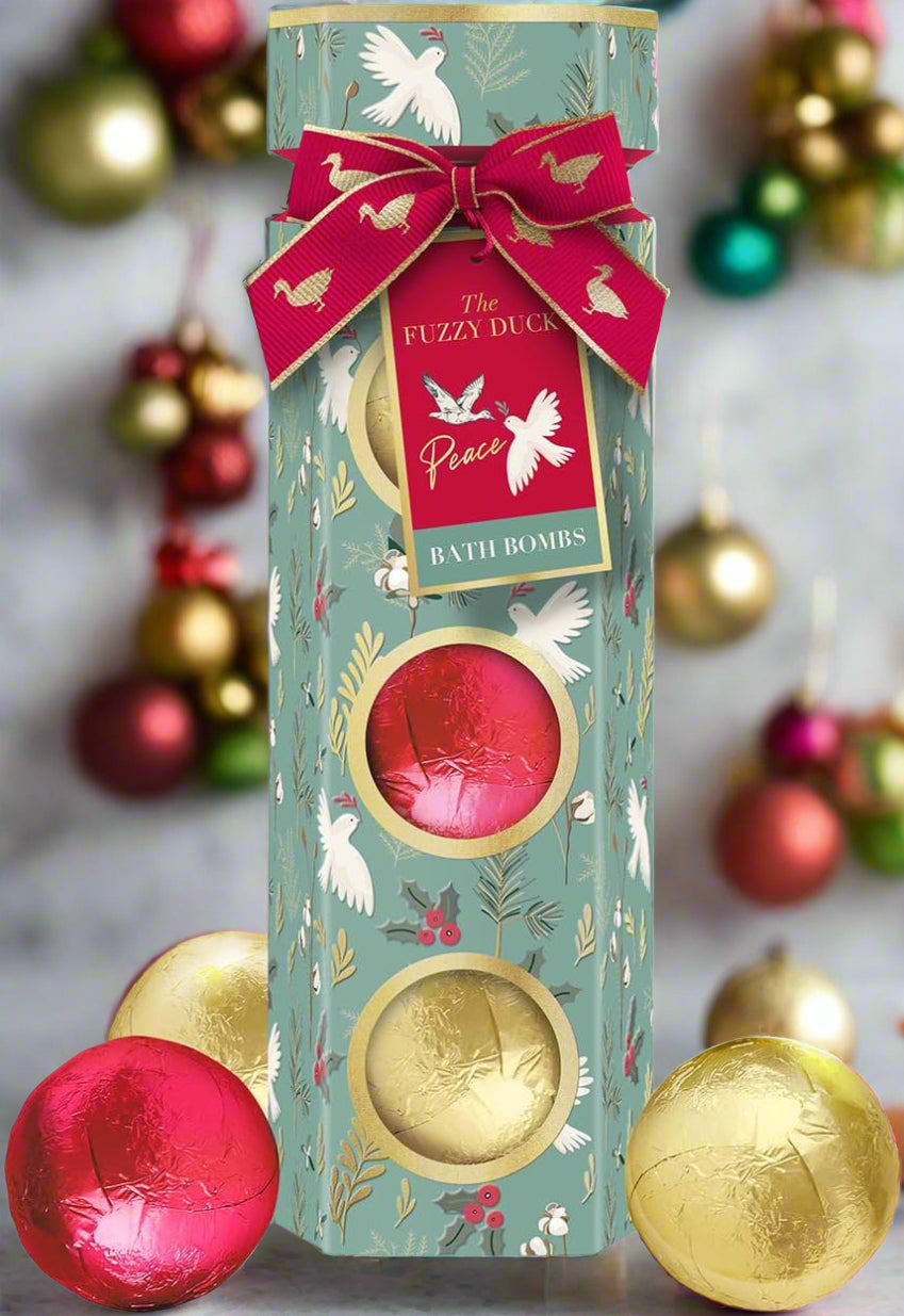 Bath bombs in a decorative cylindrical packaging with a bow and 'The Fuzzy Duck' label.